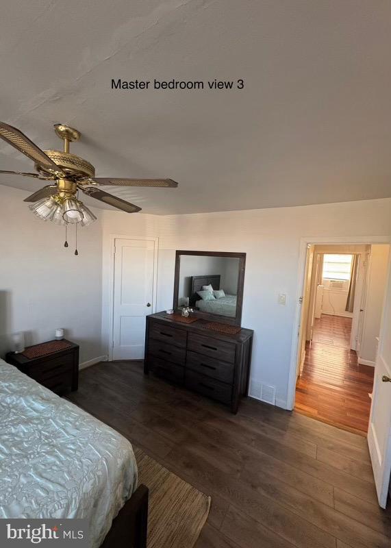 bedroom with ceiling fan and dark wood-type flooring