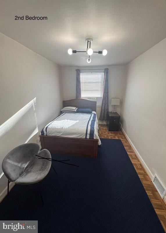 bedroom featuring dark parquet flooring and ceiling fan