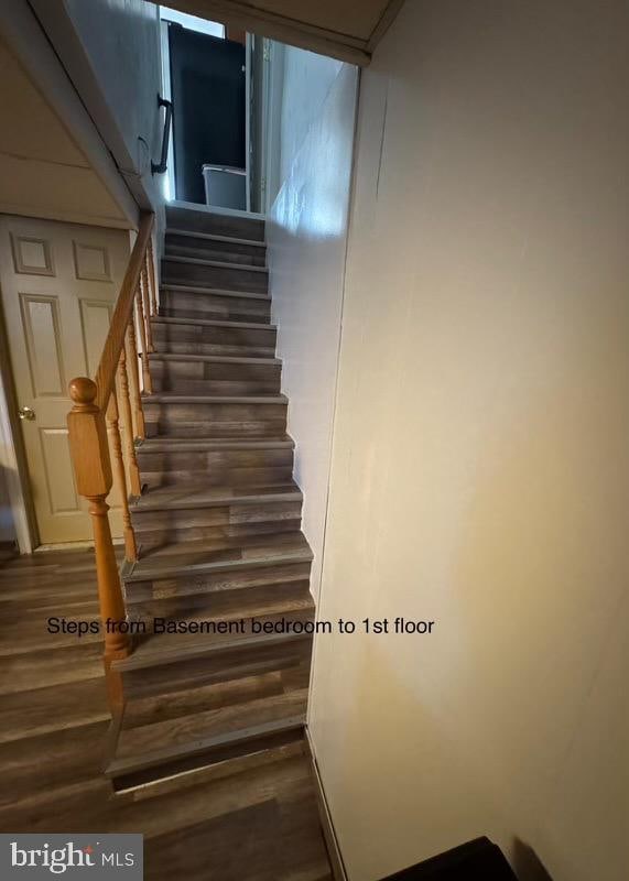 stairway featuring hardwood / wood-style flooring