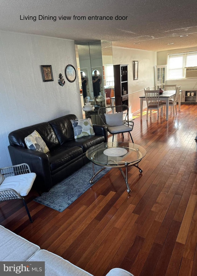 living room featuring hardwood / wood-style flooring and a textured ceiling