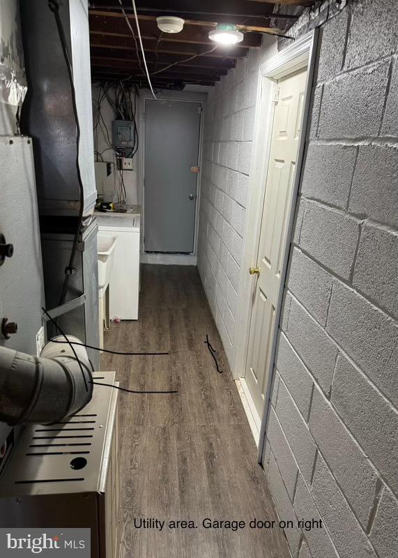 basement with dark hardwood / wood-style flooring and washer / dryer