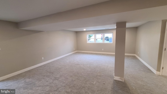 basement featuring light colored carpet