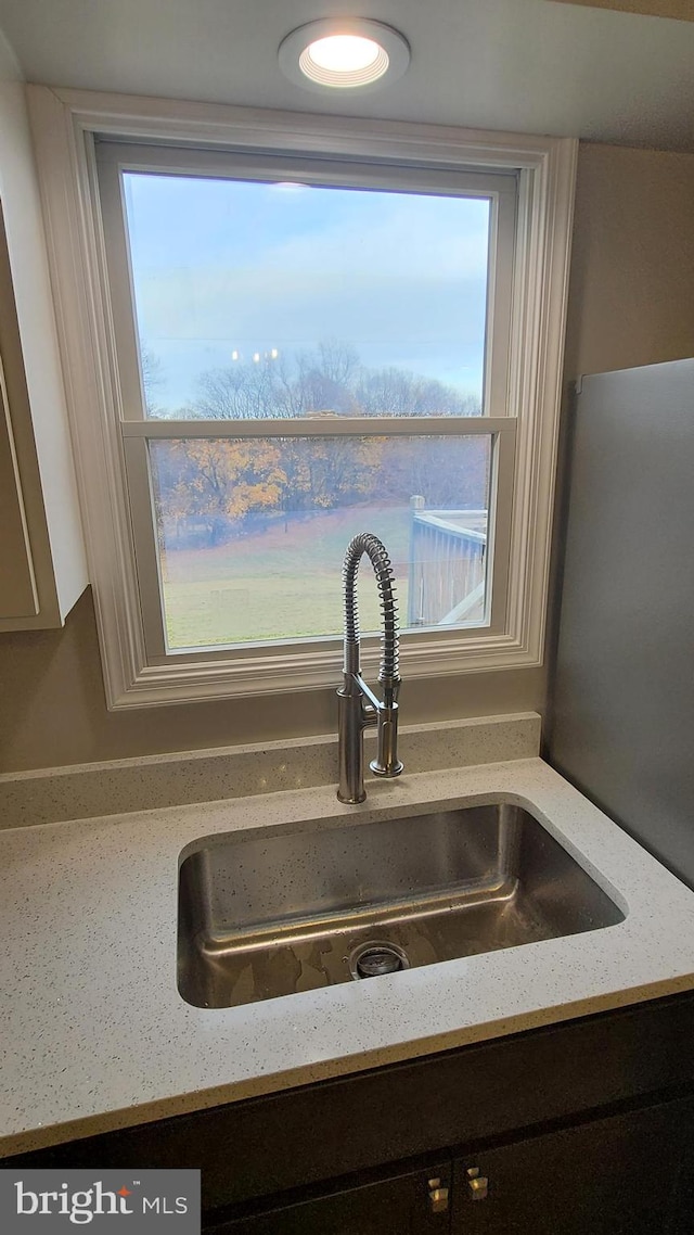 details with light stone countertops and sink