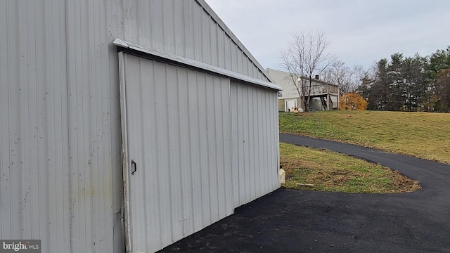 view of outbuilding featuring a lawn