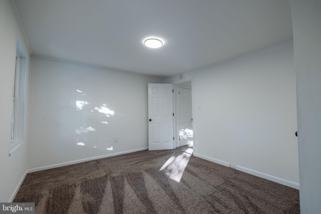 carpeted empty room with crown molding