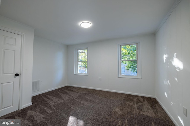 carpeted spare room featuring ornamental molding