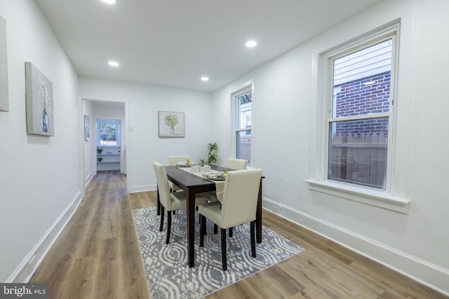 dining area with plenty of natural light and hardwood / wood-style floors