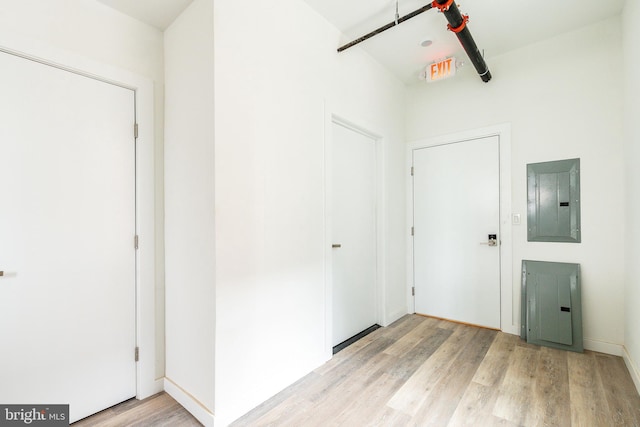 foyer entrance featuring electric panel and light hardwood / wood-style floors