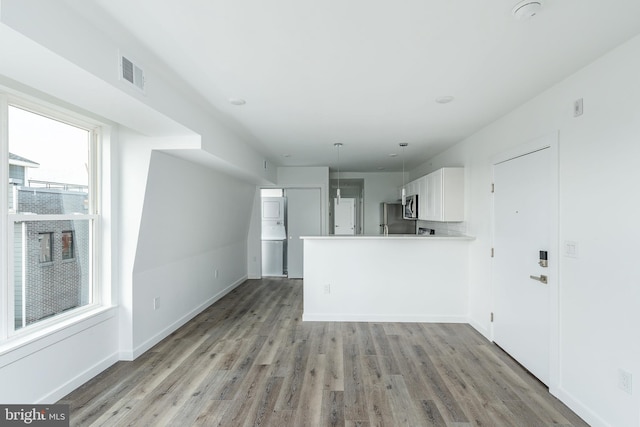 unfurnished living room with light hardwood / wood-style floors