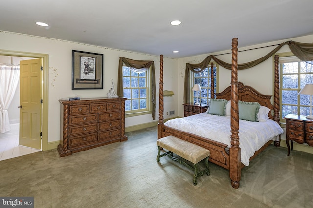 bedroom with light carpet and multiple windows