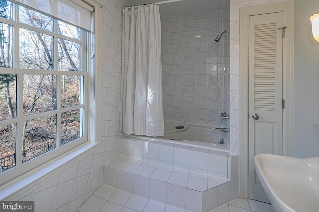 bathroom featuring tile patterned floors, a wealth of natural light, and shower / bathtub combination with curtain