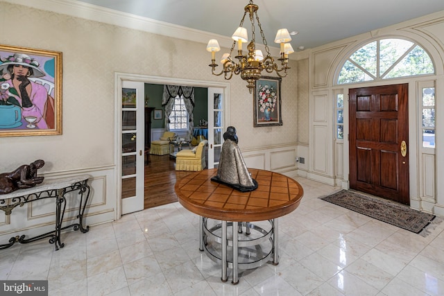 entryway featuring a chandelier and ornamental molding