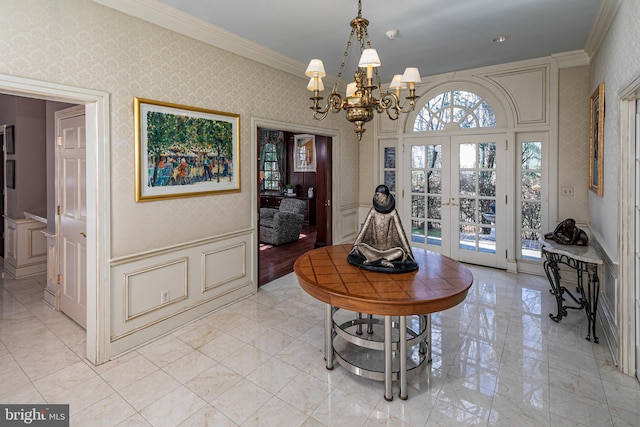 entryway with french doors, an inviting chandelier, and ornamental molding