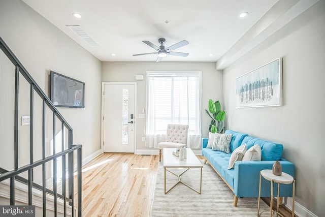 living room featuring light wood-type flooring and ceiling fan