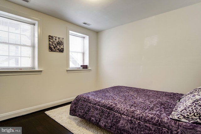 bedroom with hardwood / wood-style floors