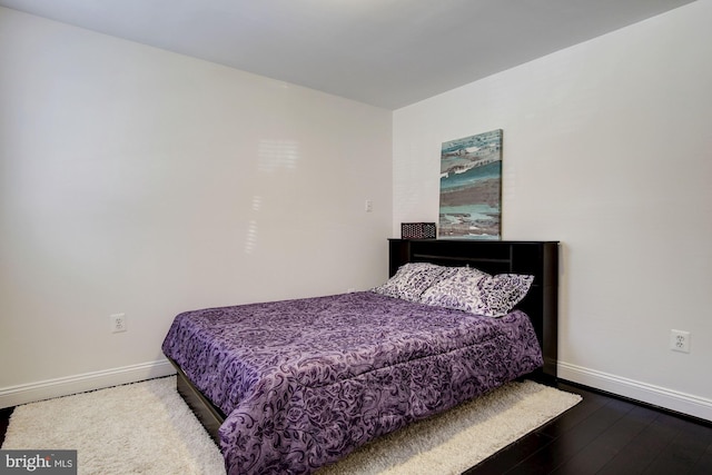 bedroom with hardwood / wood-style flooring