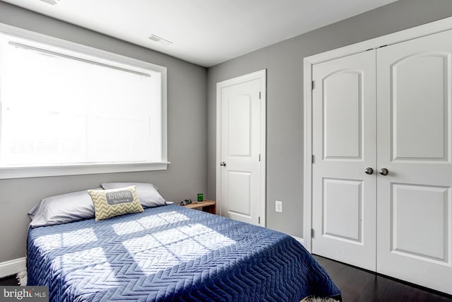 bedroom with dark hardwood / wood-style floors