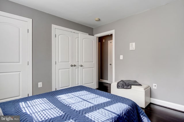 bedroom featuring dark hardwood / wood-style flooring and a closet