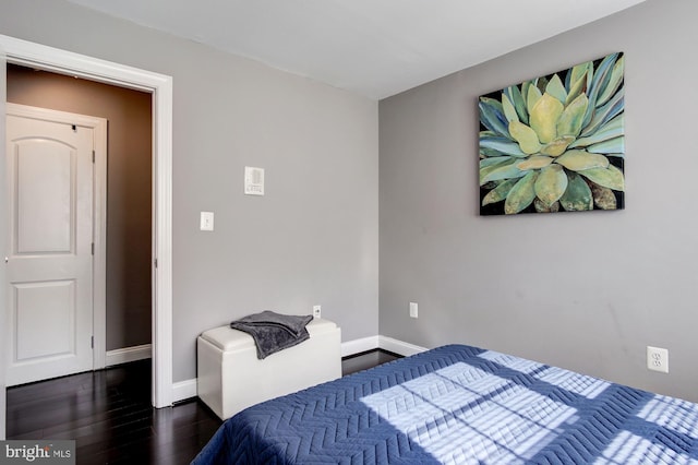 bedroom with dark hardwood / wood-style flooring