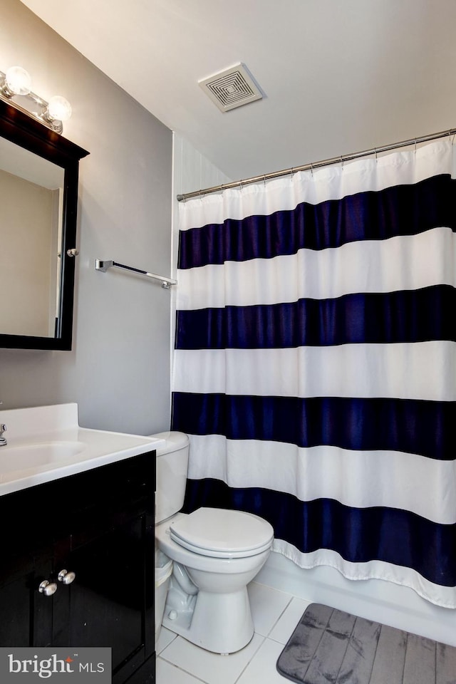 bathroom featuring tile patterned floors, a shower with curtain, vanity, and toilet