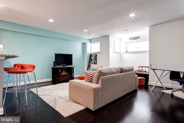 living room featuring dark wood-type flooring