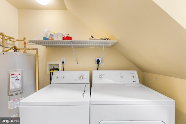 laundry area with electric water heater and washing machine and clothes dryer