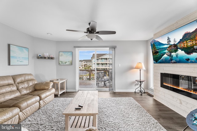 living room with dark hardwood / wood-style floors and ceiling fan