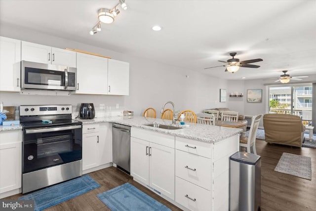 kitchen with kitchen peninsula, white cabinetry, and appliances with stainless steel finishes