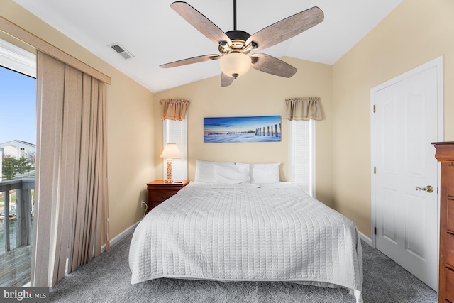 carpeted bedroom featuring multiple windows, lofted ceiling, and ceiling fan