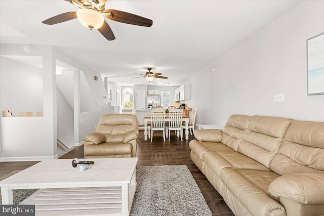 living room featuring dark hardwood / wood-style floors and ceiling fan