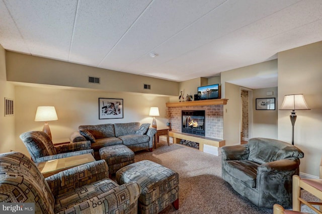 carpeted living room featuring a fireplace