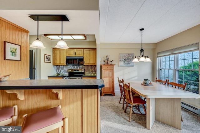 kitchen with decorative backsplash, pendant lighting, light colored carpet, and stainless steel stove