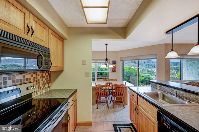 kitchen featuring decorative backsplash, sink, black appliances, light tile patterned floors, and decorative light fixtures