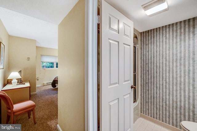 hallway with light carpet and a baseboard radiator