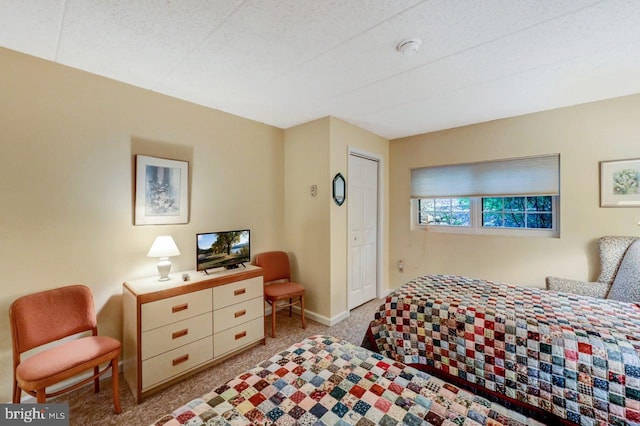 bedroom featuring a closet and light colored carpet