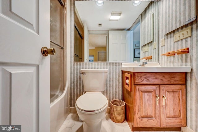 full bathroom featuring shower / washtub combination, tile patterned flooring, vanity, and toilet