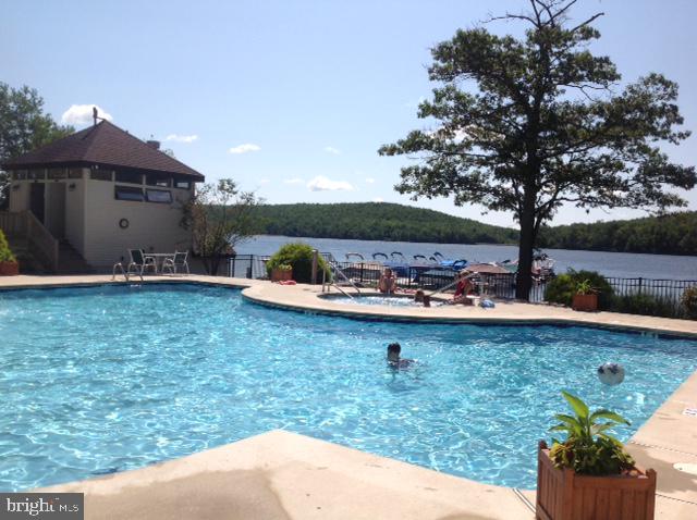 view of pool featuring a water view