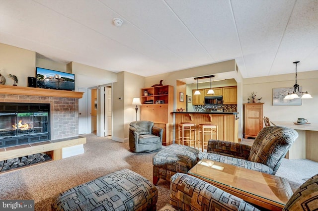 carpeted living room with a brick fireplace