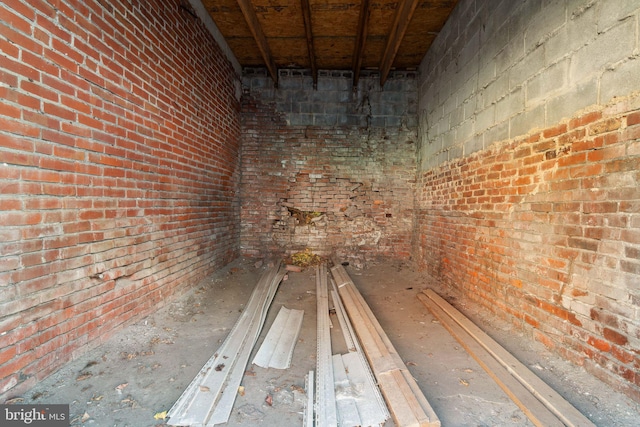 interior space featuring brick wall