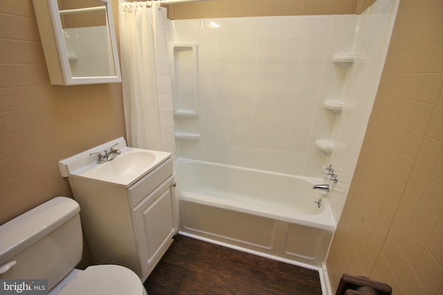 full bathroom featuring vanity, toilet, shower / bathtub combination with curtain, and tile walls