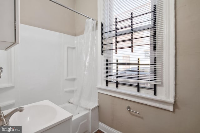 bathroom featuring shower / bath combo and sink