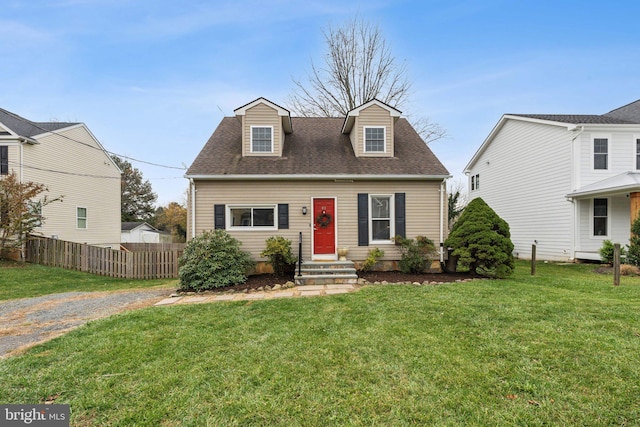 cape cod home featuring a front yard