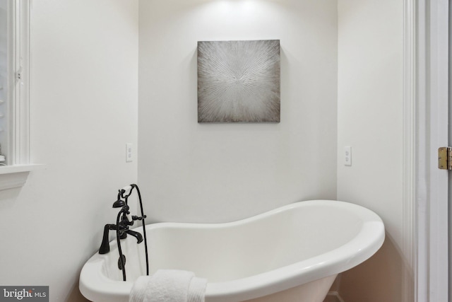 bathroom with a tub to relax in