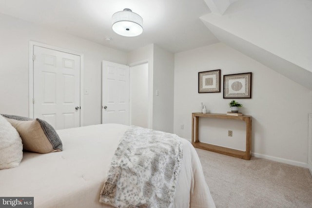 bedroom with light carpet and vaulted ceiling