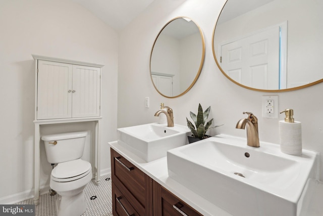 bathroom featuring tile patterned flooring, vanity, toilet, and lofted ceiling