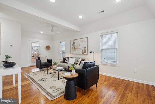 living room with beam ceiling, ceiling fan, and wood-type flooring