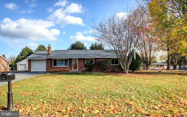 ranch-style house featuring a front yard and a garage