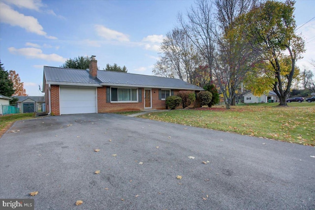 single story home featuring a garage and a front yard