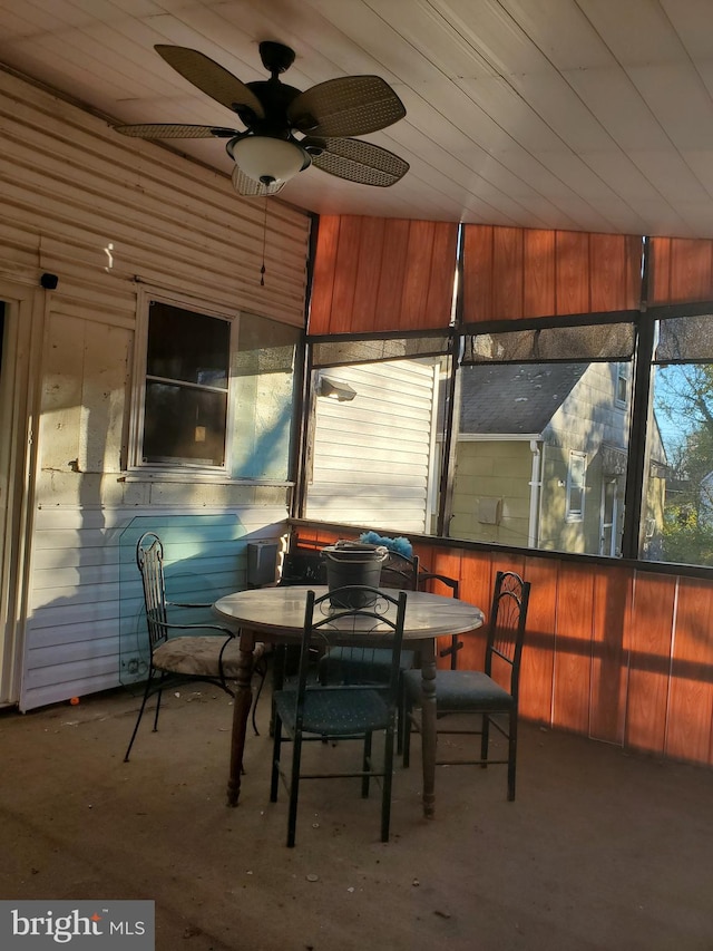 sunroom with ceiling fan and wooden ceiling