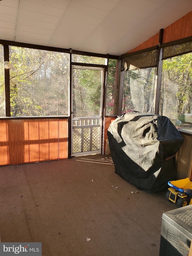 unfurnished sunroom featuring vaulted ceiling